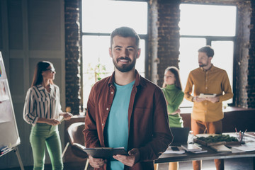 Photo of cheerful toothy bearded man having attended courses at business analysis listening to coach speaking about most profitable ways of income increase