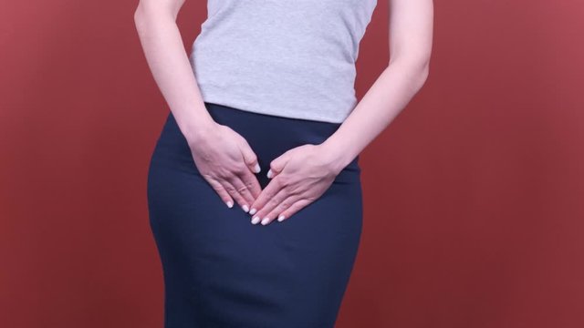 sick business woman with hands holding pressing her crotch lower abdomen. Medical or gynecological problems, healthcare concept