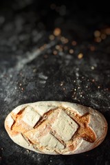 Bakery products. Crispy, beautiful bread on a dark background. Buckwheat, without yeast, wheat bread with flax and sunflower seeds. Top view, place for text.