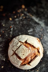 Bakery products. Crispy, beautiful bread on a dark background. Buckwheat, without yeast, wheat bread with flax and sunflower seeds. Top view, place for text.