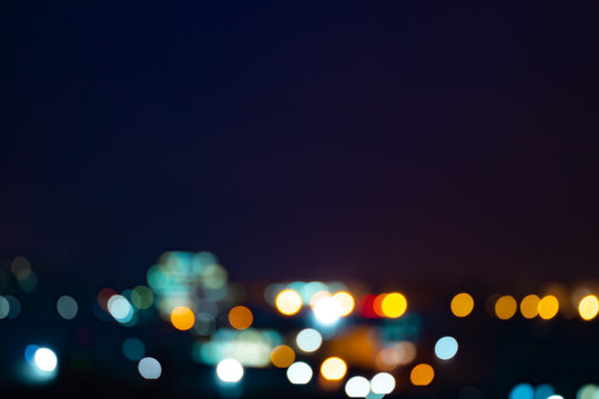 Abstract background of urban night blurred bokeh cityscape © assemb