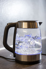  Electric kettle boils in the kitchen