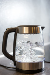  Electric kettle boils in the kitchen