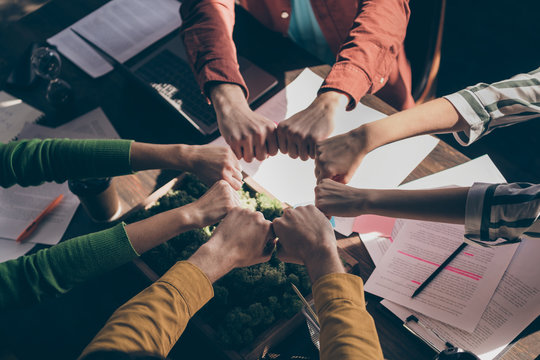 Top Above High Angle View Cropped Photo Marketers Partners Put Fists Together Round Circle Support Start-up Goals Teambuilding Training Concept Above Table Desk Workstation Workplace