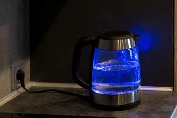  Electric kettle boils in the kitchen