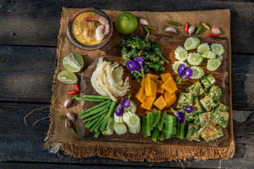 Thai Traditional Food : Shrimps chili dip or nam prik with shrimps (Nam Prik Goong Sod) with blanched vegetables and cha-om omelets on wooden backgroud.