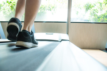 Close up of young men's sneakers running on the treadmill in the gym