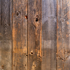 Old wooden boards with knotholes as a background.