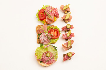 Assortment of canapes, sandwich with ham, cheese and lettuce