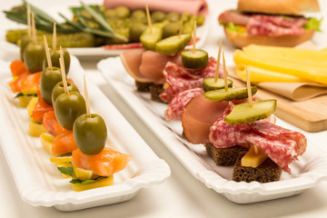 Assortment of canapes with salmon, bacon, cheese, pickles