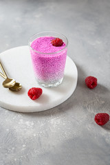 Healthy chia pudding with almond milk and pink matcha in a glass. Superfoods, healthy nutrition, dieting concept