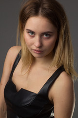 Naklejka premium portrait of a young girl in a leather dress