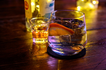 Glass of gin with tonic water, orange and ice