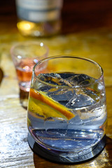 Glass of gin with tonic water, orange and ice