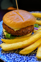 Veggy burger served with fried potato and hot chuthey sauce