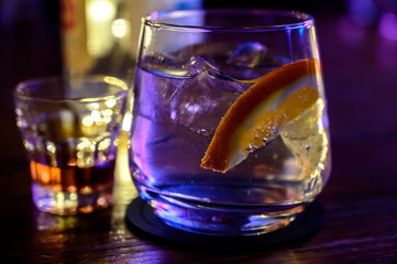 Glass of gin with tonic water, orange and ice