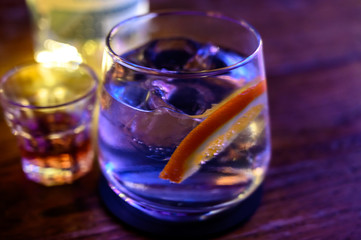 Glass of gin with tonic water, orange and ice