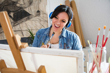 Beautiful woman painting and singing