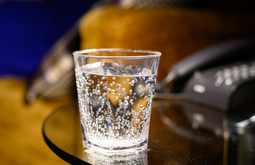 Plastic transparent glass with sparkling water with bubbles