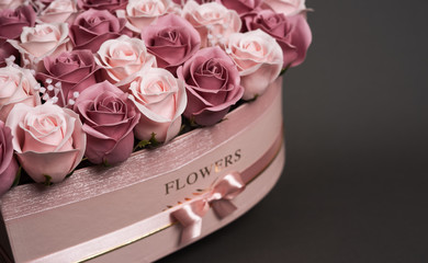 Flowers in bloom: Bouquet of pink roses on a gray background.