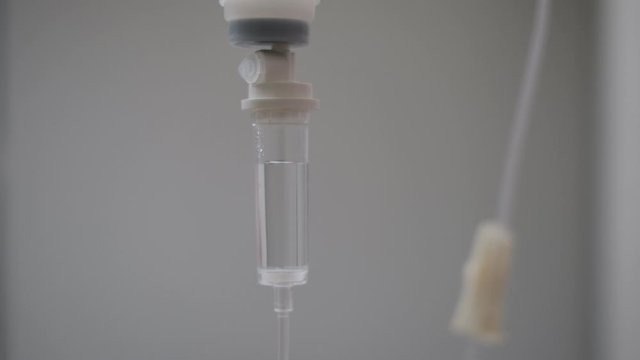 Close up saline dropping solution tube on white room background in  The hospital.Saline solution for intravenous infusion