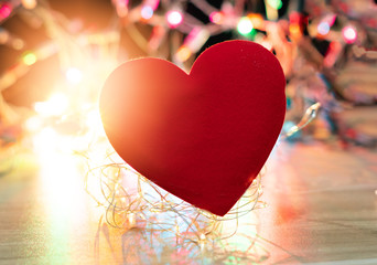 Red heart on color bokeh and bright background,