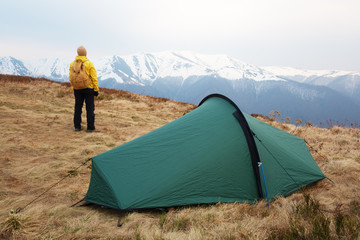 Tourist pitch a tent in spring mountains. Amazing highland. Landscape photography © Ivan Kmit