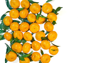 Healthy food.  Fresh orange-yellow tangerines with green leaves on a white background.  Top view.