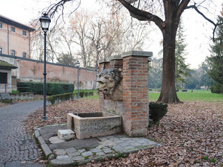 Ferrara, Italy. Massari public park, fountain with lion's head, in winter.