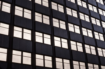 Fototapeta premium windows of office building with golden reflections