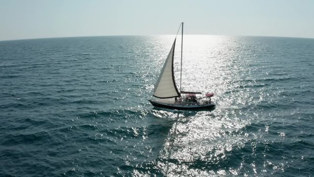 Yacht sailing on opened sea. Sailing boat. Yacht from drone. Yachting video. Yacht from above. Sailboat from drone. Sailing video. Yachting at windy day. Yacht. Sailboat.