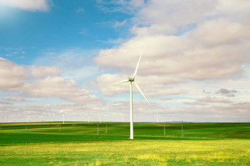 Wind turbines against beautiful blue sky with clouds. Eolic park.