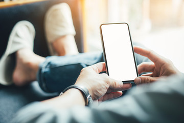 Mockup image blank white screen cell phone.man hand holding texting using mobile sitting at coffee shop.background empty space for advertise text.people contact marketing business,technology 