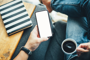 Mockup image blank white screen cell phone.man hand holding texting using mobile sitting at coffee shop.background empty space for advertise text.people contact marketing business,technology 
