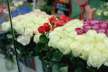 Colorful roses flowers behind the shop window. Valentine's day. Mother's Day! Holidays concept.