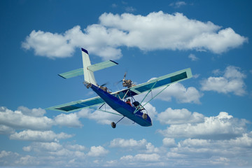 A small rear prop plane flying against the sky