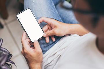 Mockup image blank white screen cell phone.woman hand holding texting using mobile on desk at coffee shop.background empty space for advertise text.people contact marketing business,technology 