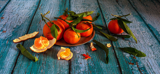 Still life with tangerines and leaves. Fresh and ripe citrus fruits. Healthy and tasty food or dessert.