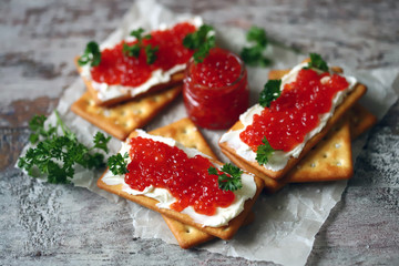 Crackers with white cheese and red caviar. Keto diet. Healthy breakfast. Keto snack.