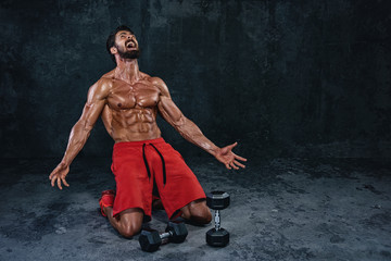 Bodybuilder Kneeling On The Floor and Screaming at Bodybuilding Gods