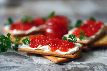 Crackers with white cheese and red caviar. Keto diet. Healthy breakfast. Keto snack.