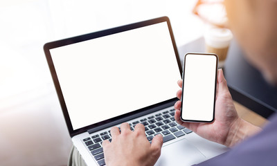 mockup image blank screen computer,cell phone with white background for advertising text,hand woman using laptop texting mobile contact business search information on desk in cafe.marketing,design