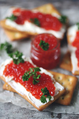 Crackers with white cheese and red caviar. Keto diet. Healthy breakfast. Keto snack.