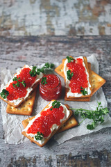 Crackers with white cheese and red caviar. Keto diet. Healthy breakfast. Keto snack.