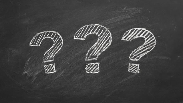 Three question marks drawn in chalk on a blackboard.