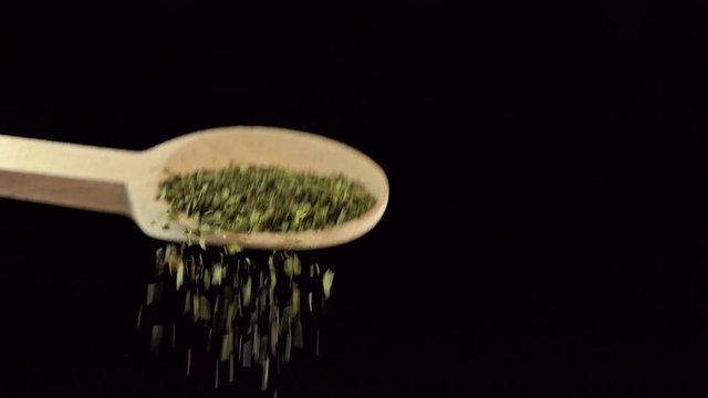 One spoon of dried lovage. Spices and food ingredients.