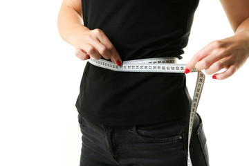woman measures the size of the waist with a tape centimeter