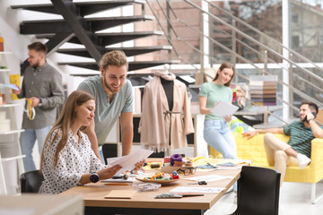 Fashion designers creating new clothes in studio