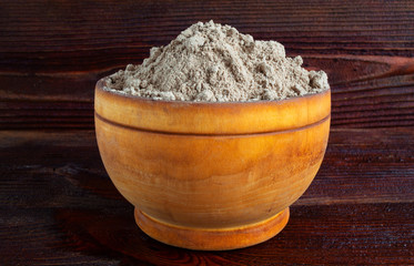 Flax seed flour in wooden bowl, close-up