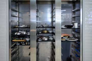 Dirty dishware and food waste on tray keeping in compartment